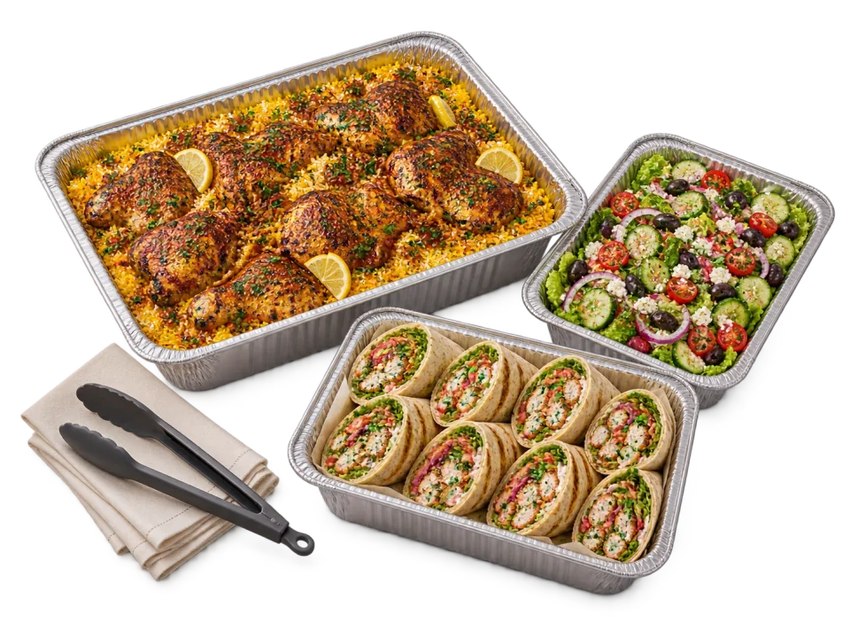 Three generous catering trays with wraps, chicken and rice, and fresh salad.