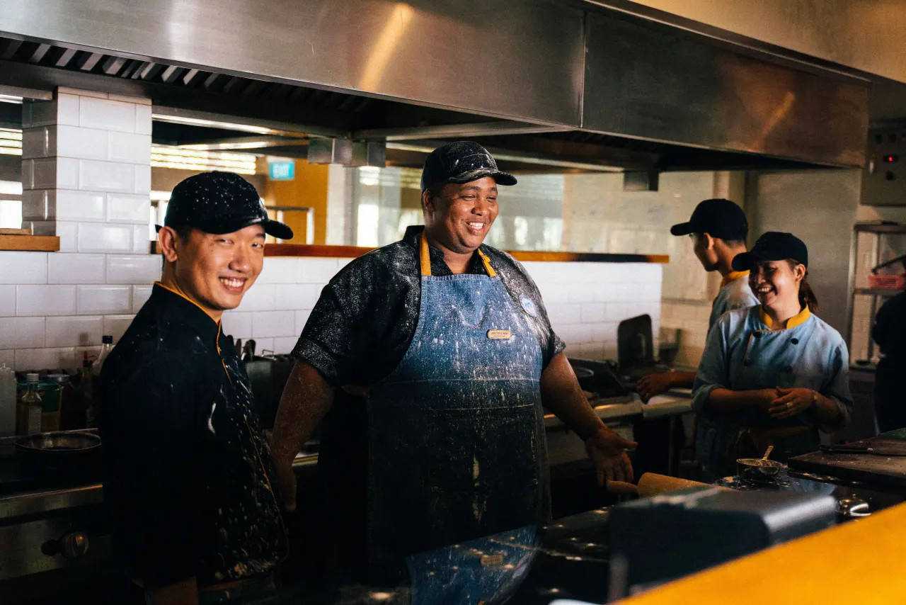 A restaurant team sharing a smile during service